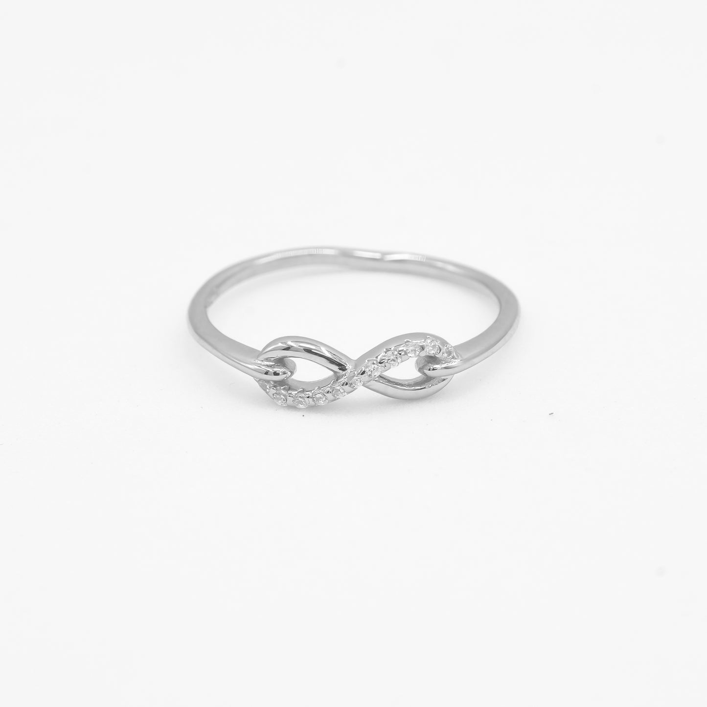 Close-up of Noor 925 silver infinity loop ring with sparkle stone detailing