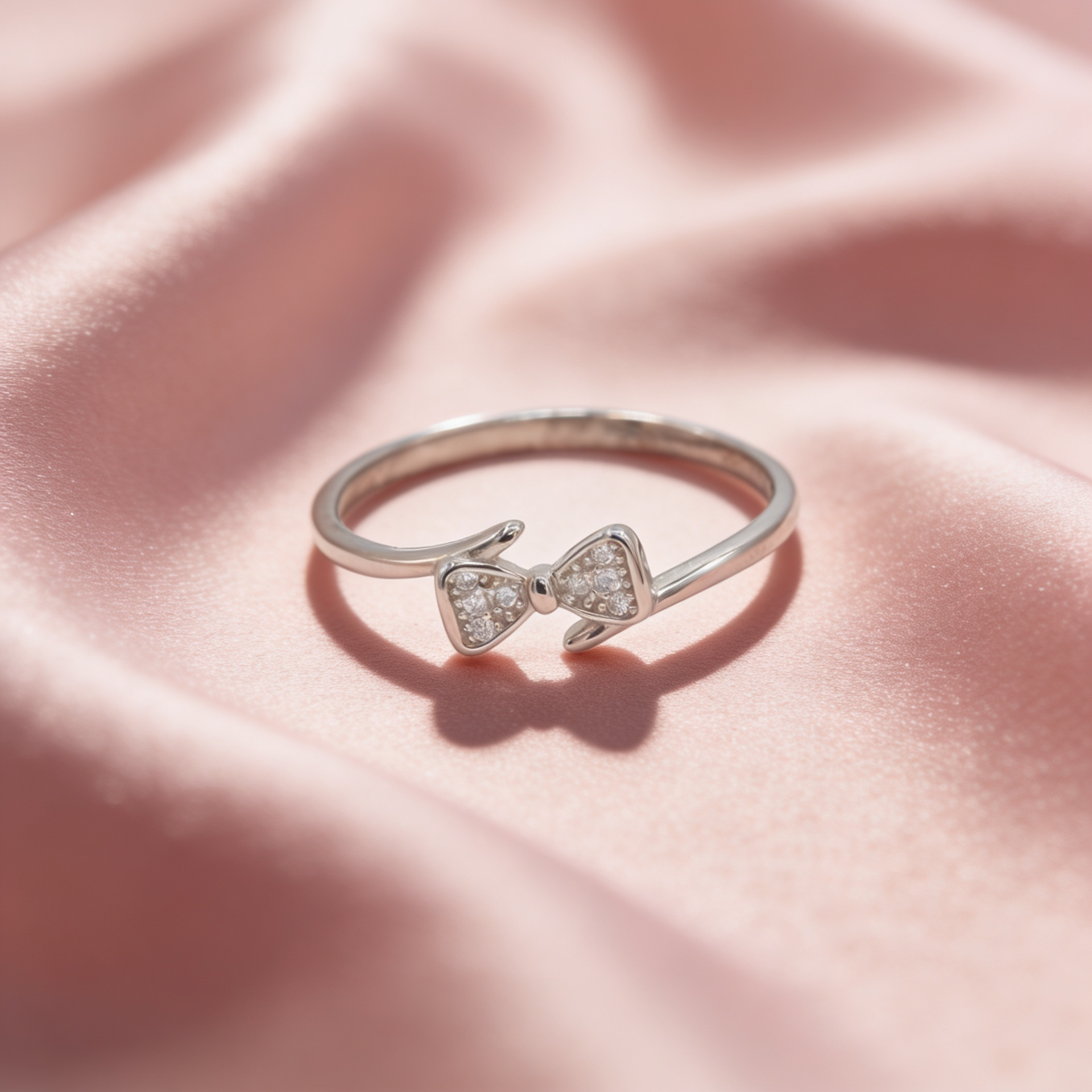Naira 925 silver bow ring for women by Zyrene on pink satin background